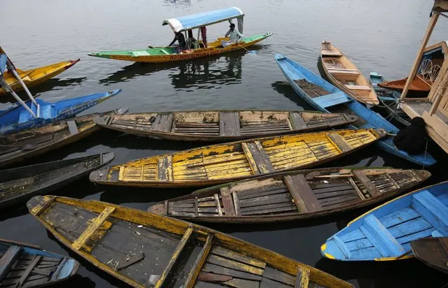 Kashmiri boatmen row their boat in the world famous Dal Lake in Srinagar, summer capital of Indian Kashmir, 04 May 2016. The region witnessed moderate rains bringing drop in temperature. (Photo by Farooq Khan/EPA)