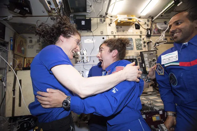 In this photo made available by NASA astronaut Jessica Meir on September 29, 2019, Christina H. Koch, left, and Meir greet each other after Meir's arrival on the International Space Station. On Friday, Sept. 4, 2019, NASA announced that the International Space Station’s two women will pair up for a spacewalk on Oct. 21 to plug in new batteries. (Photo by NASA via AP Photo)