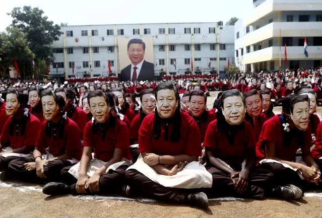 Indian school children wear face masks of Chinese President Xi Jinping to welcome him on the eve of his visit in Chennai, India, Thursday, October 10, 2019. Chinese President Xi Jinping is coming to India to meet with Prime Minister Narendra Modi on Friday, just weeks after Beijing supported India's rival Pakistan in raising the issue of New Delhi's recent actions in disputed Kashmir at the U.N. General Assembly meeting. (Photo by R. Parthibhan/AP Photo)