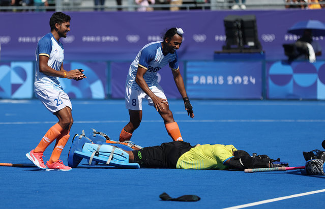 Raj Kumar Pal (L) Hardik Singh (C) and Sreejesh Parattu Raveendran of Team India celebrate following victory in during the Men's Bronze Medal match between India and Spain on day thirteen of the Olympic Games Paris 2024 at Stade Yves Du Manoir on August 08, 2024 in Paris, France. (Photo by Maja Hitij/Getty Images)