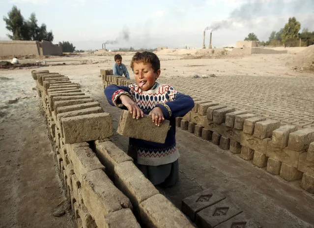 Hazrat 7, works at a brick-making factory in Jalalabad December 17, 2013. (Photo by Parwiz Parwiz/Reuters)