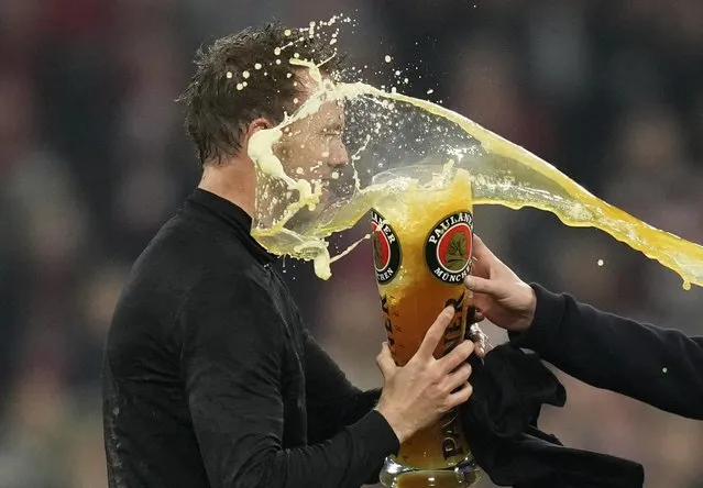 Bayern's head coach Julian Nagelsmann celebrates with players at the end of the German Bundesliga soccer match between Bayern Munich and Borussia Dortmund, at the Allianz Arena, in Munich, Germany, Saturday, April 23, 2022. (Photo by Matthias Schrader/AP Photo)
