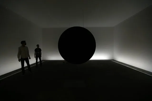 Visitors look at the “Dark Matter” installation by Troika (2014) at the Art Unlimited exhibition at the Art Basel fair in Basel June 17, 2014. Founded by gallerists in 1970, the Art Basel is an international art show which is held annually in Basel, Hong Kong and Miami Beach. (Photo by Denis Balibouse/Reuters)