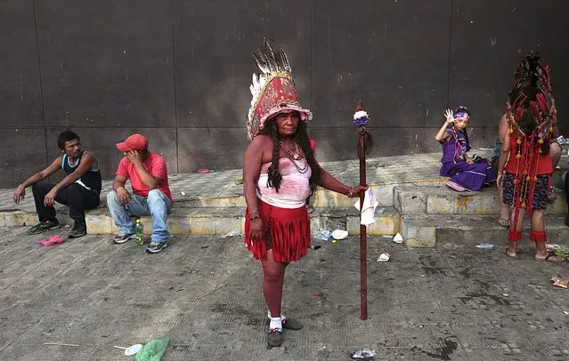 A woman dressed as an indigenous person poses for pictures during celebrations honouring the patron saint of Managua, Santo Domingo de Guzman, in Managua, Nicaragua August 9, 2015. (Photo by Oswaldo Rivas/Reuters)