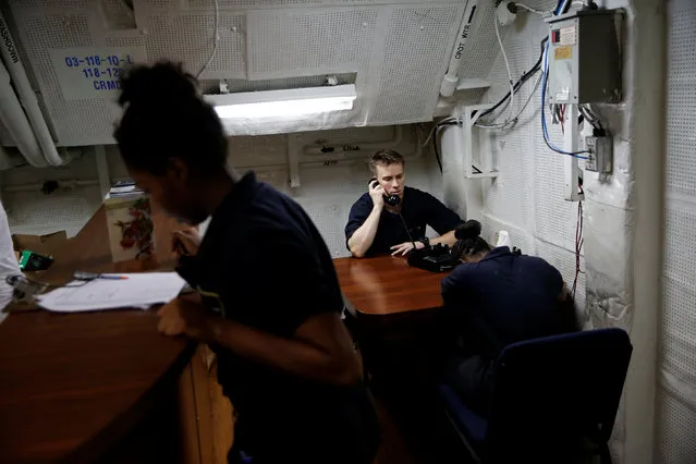 US Navy sailors use phones on board the USS Harry S. Truman aircraft carrier in the eastern Mediterranean Sea, June 14, 2016. (Photo by Baz Ratner/Reuters)
