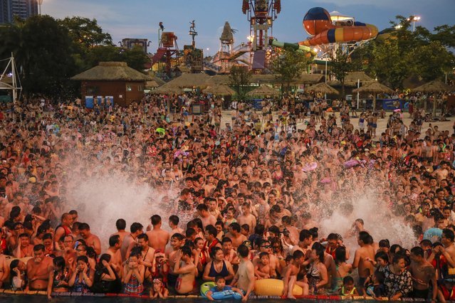Tourists crowd a water park in Wuhan city, central China's Hubei province on July 15, 2017. (Photo by Imaginechina/Rex Features/Shutterstock)
