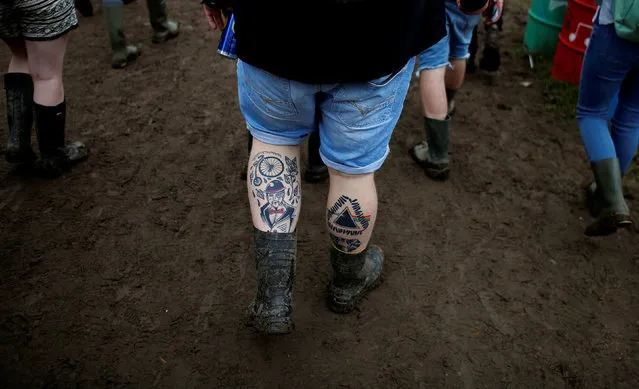 Revellers walk in the mud during the Glastonbury Festival at Worthy Farm in Somerset, Britain June 23, 2016. (Photo by Stoyan Nenov/Reuters)