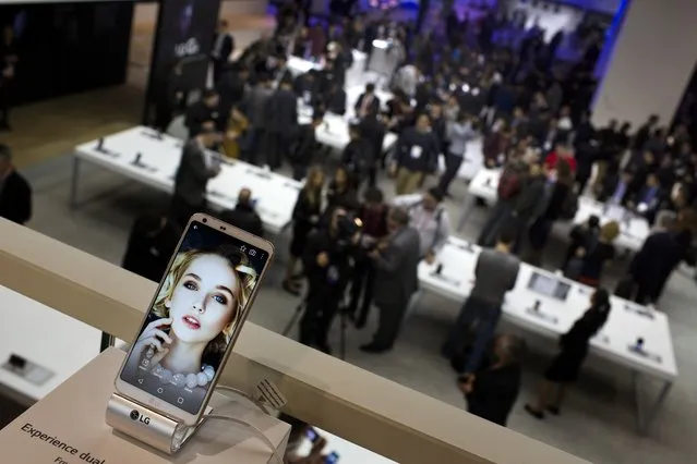 In this February 27, 2017 file photo, people crowd at the LG stand during the Mobile World Congress wireless show in Barcelona, Spain. Sony and Amazon are the latest companies to pull out of a major European technology show over virus fears.Sony said Monday it’s scrapping its appearance at Mobile World Congress, the world’s biggest mobile industry trade fair, in Barcelona, Spain later this month. (Photo by Emilio Morenatti/AP Photo/File)