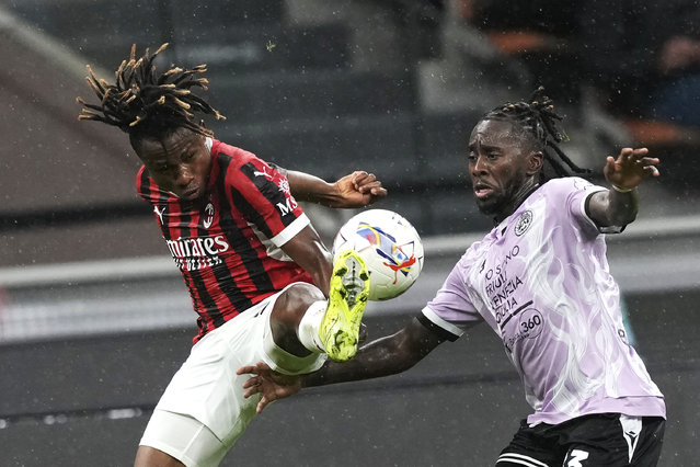 AC Milan's Samuel Chukwueze, left, and Udinese's Jordan Zemura challenge for the ball during the Serie A soccer match between AC Milan and Udinese at the San Siro Stadium, in Milan, Italy, Saturday, October 19, 2024. (Photo by Antonio Calanni/AP Photo)