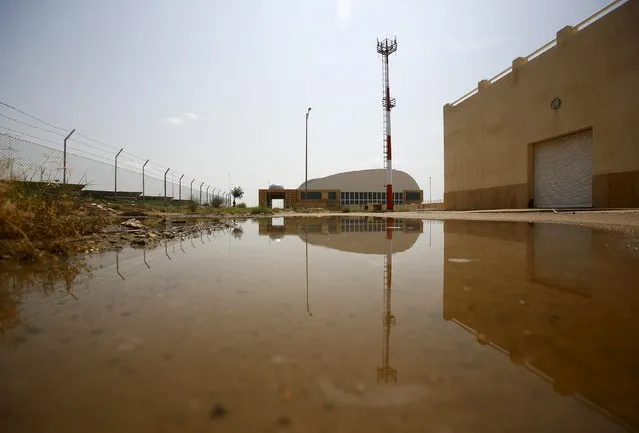 Buildings are reflected in a puddle after rains inside the premises of the Jaisalmer Airport in desert state of Rajasthan, India, August 13, 2015. (Photo by Anindito Mukherjee/Reuters)