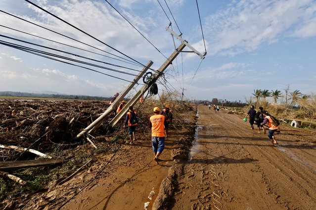 Filipino government workers clear debris along a road affected by Typhoon Usagi in the coastal municipality of Santa Ana, Cagayan province, Philippines, 15 November 2024. (Photo by Francis R. Malasig/EPA/EFE)