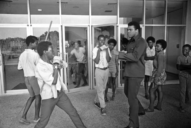 Bernard White, 16, of Charleston good naturally challenges Muhammad Ali, as the former heavyweight champ heads to a news conference, June 30, 1971 at Charleston Municipal Auditorium in Charleston. Ali will box in two exhibition bouts at Stoney Field. One against Alex Scotty Mack and the other against Ed Brook. (Photo by Lou Krasky/AP Photo)