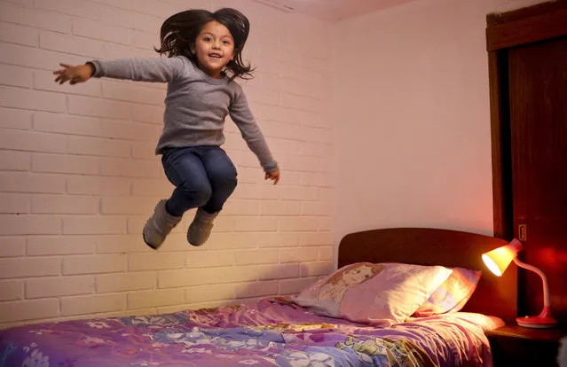 In this July 9, 2017 photo,  Mathilda jumps on her bed as the poses for a picture at her home in Santiago, Chile. Mathilda, 6, was born a boy but began identifying herself as a girl one year ago, and is accepted as a girl by her classmates and teachers. (Photo by Esteban Felix/AP Photo)