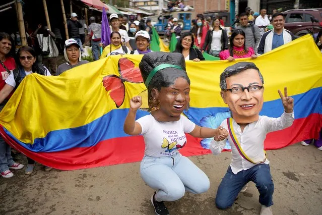 People wearing masks depicting Colombia's President Gustavo Petro and Vice President Francia Marquez wait for the arrival of Francia Marquez for her symbolic inauguration ceremony in her hometown, in Suarez, Colombia on August 13, 2022. (Photo by Mariana Greif/Reuters)