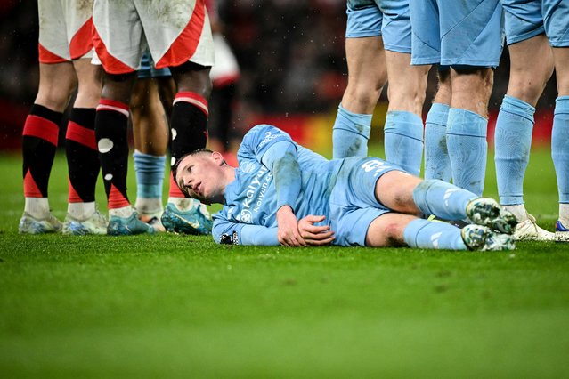 Nottingham Forest's Scottish midfielder #08 Elliot Anderson reacts as he lays down on the picth during the English Premier League football match between Manchester United and Nottingham Forest at Old Trafford in Manchester, north west England, on December 7, 2024. (Photo by Oli Scarff/AFP Photo)