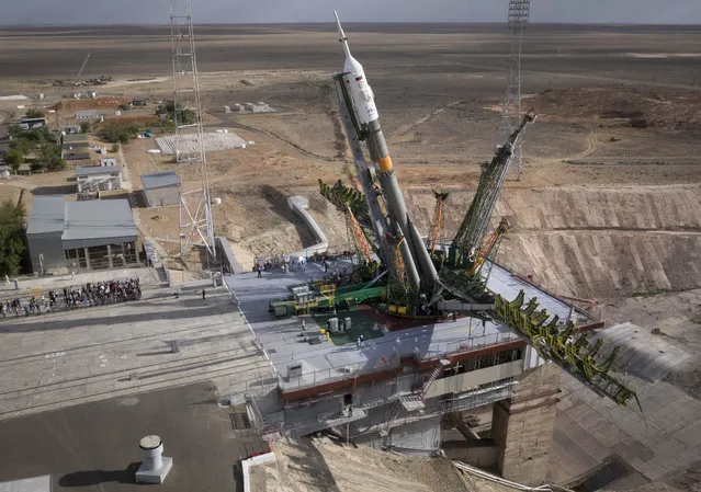 In this aerial photo, the Russian Soyuz TMA-18M space ship that will carry new crew to the International Space Station is fixed vertical at the launch pad in Russian leased Baikonur cosmodrome, Kazakhstan, Monday, August 31, 2015. The Russian rocket will carry Kazakhstan's cosmonaut Aydyn Aimbetov, Russian cosmonaut Sergei Volkov and Denmark's astronaut Andreas Mogensen on Wednesday, September 2. (Photo by Dmitry Lovetsky/AP Photo)