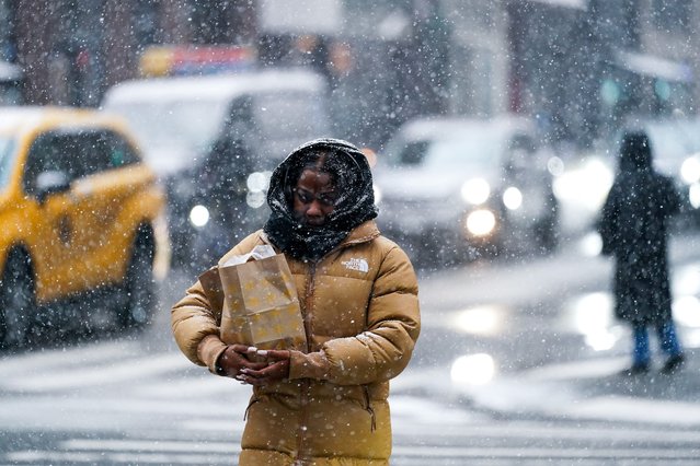 A person crosses the street during snowfall in New York City, U.S., on January 6, 2025. (Photo by Adam Gray/Reuters)
