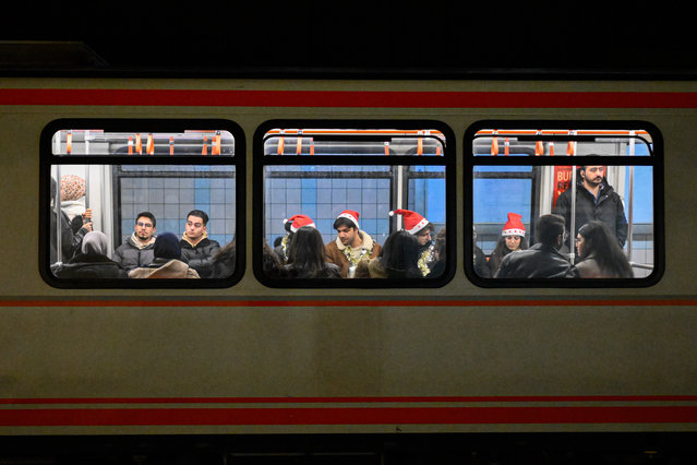 Passengers wearing festive hats sit inside a subway as they prepare to celebrate New Year's Eve in Ankara, Turkiye on December 31, 2024. (Photo by Akin Celiktas/Anadolu via Getty Images)