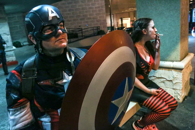 In this Saturday, September 5, 2015, photo, a man attending Dragon Con and dressed as Captain America takes a break outside his hotel in Atlanta. (Photo by Ron Harris/AP Photo)