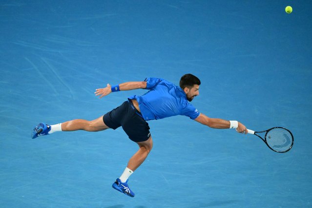 Serbia's Novak Djokovic hits a return against Spain's Carlos Alcaraz during their men's singles quarterfinal match on day ten of the Australian Open tennis tournament in Melbourne on January 21, 2025. (Photo by Yuichi Yamazaki/AFP Photo)