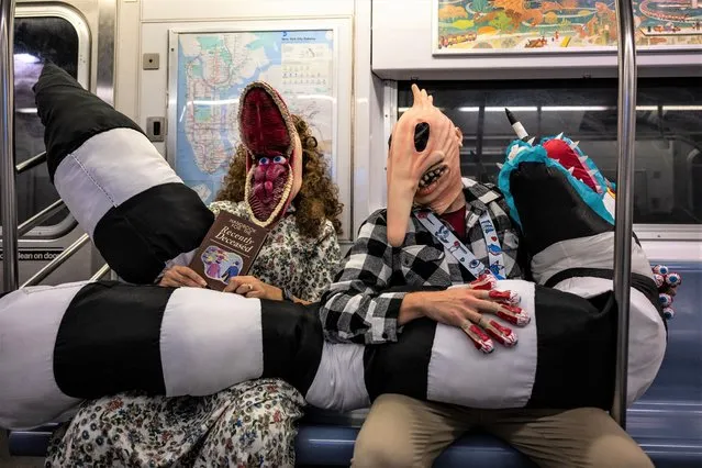 People dressed as Adam and Barbara Maitland from “Beetlejuice” ride the subway after leaving New York Comic Con 2022 on October 08, 2022 in New York City. The four-day event, which began Thursday morning at the Jacob K. Javits Convention Center in Manhattan, is expected to attract over 200,000 comic, fantasy and pop culture fans from across the country and world. (Photo by Alexi Rosenfeld/Getty Images)