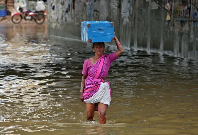 A woman carrying a box on her head wades through a water-logged subway after rains in Chennai, November 3, 2017. (Photo by P. Ravikumar/Reuters)