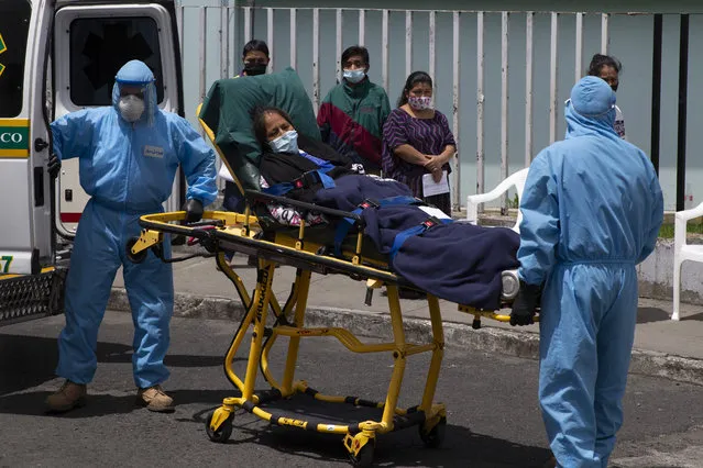 A patient with symptoms related to COVID-19 is brought to the coronavirus unit at the San Juan de Dios Hospital in Guatemala City, Tuesday, June 16, 2020. (Photo by Moises Castillo/AP Photo)