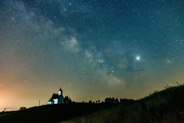 The Milky Way galaxy and the Jupiter (bottom R) are pictured near Gemersky Jablonec, Slovakia, early 08 June 2019. (Photo by Peter Komka/EPA/EFE)