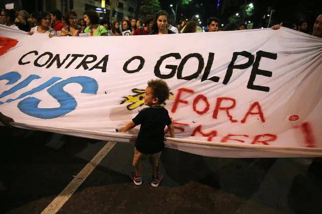 A boy stands in front of a banner that reads “against the coup” during a protest supporting Brazil's suspended President Dilma Rousseff  in Rio de Janeiro, Brazil, August 29, 2016. (Photo by Pilar Olivares/Reuters)
