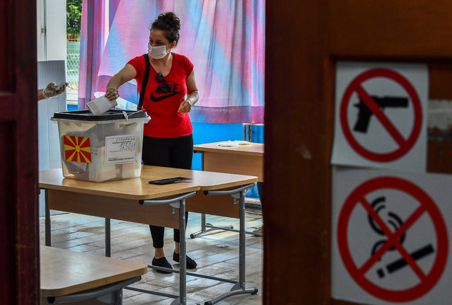 A woman wearing a protective mask votes at a polling station in the city of Strumica, Republic of North Macedonia on 15 July 2020. Almost two million Macedonians vote in a early Parliamentary elections three months after they were postponed due to the coronavirus pandemic. (Photo by Georgi Licovski/EPA/EFE)