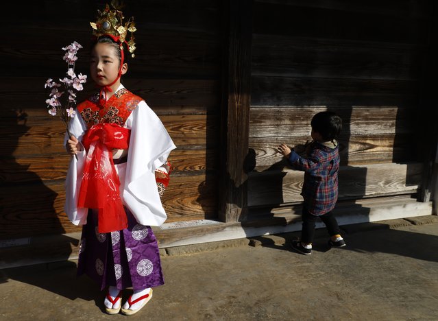 A young girl dressed in Heian period attire stands after participating to a parade along the Ono river in Sawara, east of Tokyo, Japan, 02 March 2025. Hina Matsuri, also known as Doll's Day or Girls' Day, is a special day in Japan celebrated annually on 03 March, during which families with daughters several days before the festival display a set of ornamental dolls called hina-ningyo, which represent the imperial court of the Heian period. (Photo by Franck Robichon/EPA)