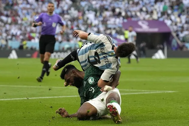 Saudi Arabia's Firas Al-Buraikan and Argentina's Nicolas Tagliafico challenge for the ball during the World Cup group C soccer match between Argentina and Saudi Arabia at the Lusail Stadium in Lusail, Qatar, Tuesday, November 22, 2022. (Photo by Natacha Pisarenko/AP Photo)