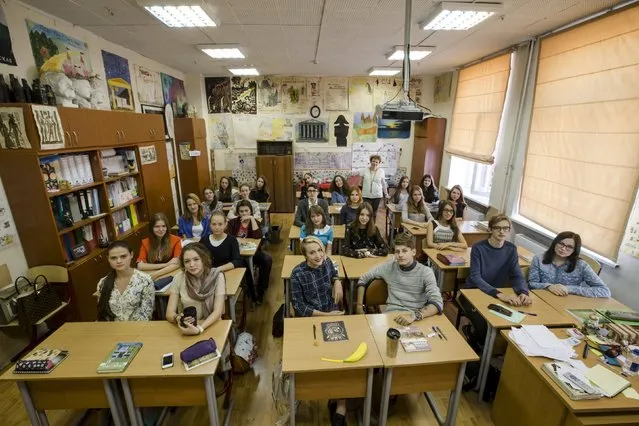Students of the 10th form of the Gymnasium 1567 pose for a group portrait together with their teacher of History, Tamara Eidelman, in Moscow, Russia, September 23, 2015. (Photo by Maxim Shemetov/Reuters)