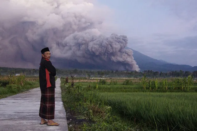 A man looks on as Mount Semeru releases volcanic materials during an eruption on Sunday, December 4, 2022 in Lumajang, East java, Indonesia. Indonesia’s highest volcano on the country’s most densely populated island of Java erupted Sunday. (Photo by AP Photo/Stringer)