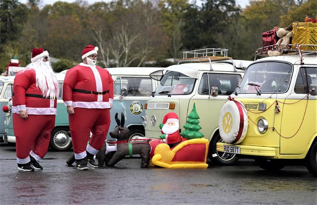 Participants dressed as Father Christmas inspect other VW Camper vans adorned with Christmas decorations ahead of the New Forest VW Santa Run at Beaulieu Motor Museum, UK on Sunday, November 27, 2022. (Photo by Andrew Matthews/PA Images via Getty Images)