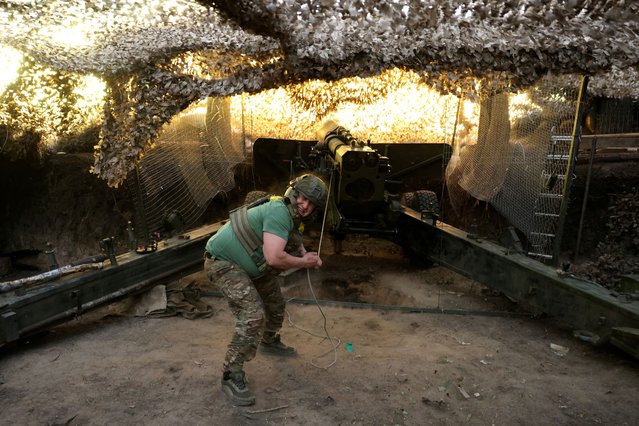 A Ukrainian serviceman fires a howitzer in Kharkiv region, Ukraine, on May 27, 2025. (Photo by Anatolii Stepanov/Reuters)