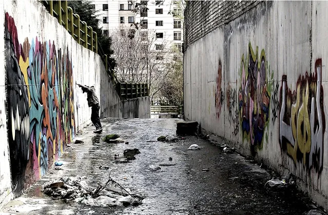 In this undated photo made available Wednesday, October 14, 2015, by film director Keywan Karimi, Iranian graffiti artist "FRZ" stands by the wall on which he paints, while being filmed for a scene of the movie called "Writing on the City" in Tehran, Iran. Karimi, an award-winning Iranian filmmaker whose work focuses on the travails of modern life and political expression in the Islamic Republic, has been sentenced to six years in prison over his movies. (Photo by Sajad Vasiresh via AP Photo)