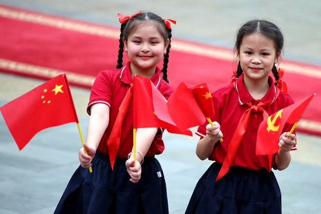 Children hold the flags of China and Communist Party of Vietnam ahead a welcome ceremony at the Presidential Palace in Hanoi, Vietnam on April 14, 2025. (Photo by Luong Thai Linh/Reuters)
