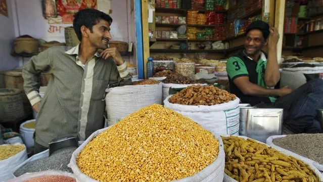 Wholesale grain, pulses and spices sellers wait for customers at a grain market in New Delhi, India, Tuesday, April 17, 2012. (Photo by Saurabh Das/AP Photo)