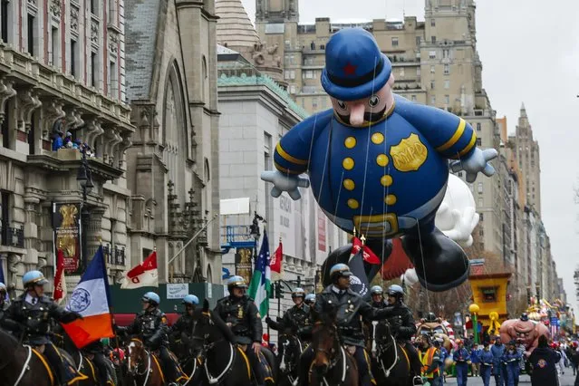 Keystone Cop balloon floats down Central Park West during the 88th Macy's Thanksgiving Day Parade in New York November 27, 2014. (Photo by Eduardo Munoz/Reuters)