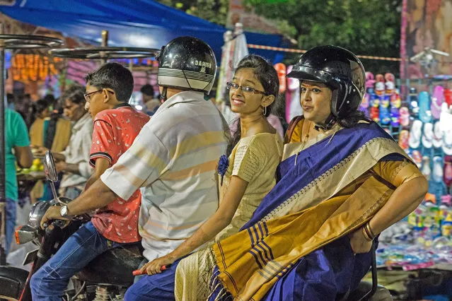 “I came across this family in a market in Kolkata. There was little time to take the picture – it wasn’t posed – and I like the surprise on the faces of the two women. A friendly exchange and then off they drove”. (Photo by George Turnbull/The Guardian)