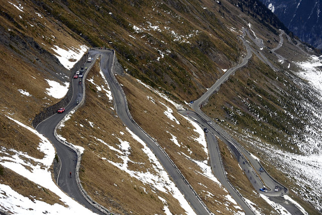 Cyclists climb the Stelvio Pass, 2,757 meters (9,045 ft) above sea level, during the 18th stage of the Giro d'Italia cycling race from Pinzolo to Laghi di Cancano, northern Italy, Thursday, October 22, 2020. (Photo by Fabio Ferrari/LaPresse via AP Photo)