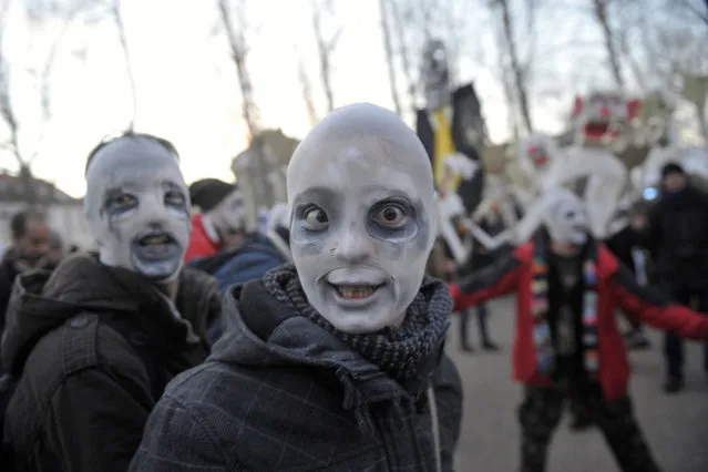 Protesters wearing masks perform during anti-austerity and anti-graft protests in Ljubljana, Slovenia, on January 11, 2013. More than 5,000 Slovenians gathered in the center of Ljubljana on Friday to protest against a corruption scandal that threatens to bring down the government. Slovenia's anti-corruption commission said earlier this week that Prime Minister Janez Jansa had been unable to explain the source of some of his income in recent years. (Photo by Srdjan Zivulovic/Reuters /The Atlantic)