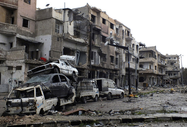 Damaged cars are piled up, used as cover from snipers in the Khaldiyeh area of Homs, on February 19, 2013. (Photo by Yazan Homsy/Reuters /The Atlantic)