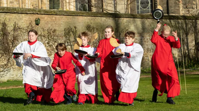 Picture dated February 20th, 2023 shows Choristers from Ely Cathedral in Cambridgeshire getting some practice in for tomorrows Shrove Tuesday pancake race in the Bishop’s Garden at the cathedral on Monday morning. (Photo by Geoff Robinson Photography/The Times)