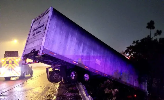 A semi truck is seen after crashing near NW 47 Ave. during Storm ETA in Miami, Florida, November 9, 2020. (Photo by FHP Miami via Reuters)