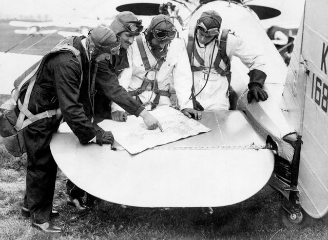 Pilots of 111 Squadron use the tail plane of a Bristol Bulldog fighter to plot their route on a map, UK, 1935. (Photo by Air Historical Branch/RAF/PA Wire)