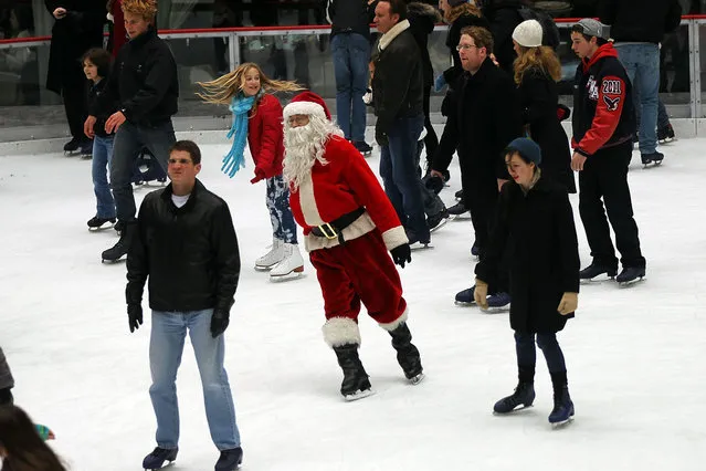 Paul Chernosky, dressed as Santa Claus skates and entertains adults and children at the ice skating rink at Rockefeller Center December 20, 2011 in New York City. With five days to go until Christmas, thousands of people flock to Rockefeller Center during the holiday season to look at the iconic Christmas tree, shop and ice skate at the rink. (Photo by Spencer Platt/Getty Images)