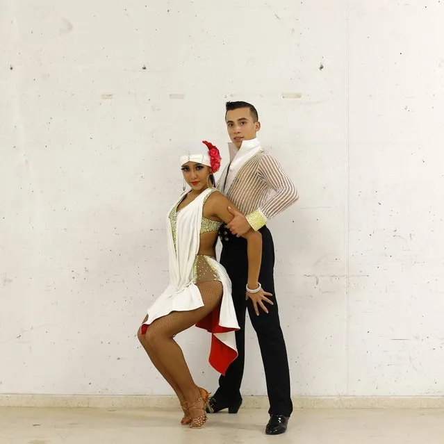 In this Saturday, November 7, 2015 photo US' dancers Elvis Collado, right, and Brianna Rios pose for a photo backstage after taking part in the World Salsa Master dance competition in Madrid. (Photo by Francisco Seco/AP Photo)