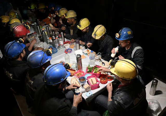 Miners break fast (iftar) at mine site, one of Turkiye's major lignite coal production centers, during the holy month of Ramadan in Soma district of Manisa, Turkiye on March 25, 2023. About 500 miners in the mining company returned to the mine site on after participating in search and rescue operation following 7.7 and 7.6 magnitude earthquakes hit multiple provinces of Turkiye occurred on Feb. 06. The miners, who work hundreds of meters below the site according to their shifts, also fulfill the requirements of the holy month of Ramadan despite their difficult professions. According to their working hours, they spend their iftar (breaking the fast) and sahur (pre-dawn) together. (Photo by Mahmut Serdar Alakus/Anadolu Agency via Getty Images)